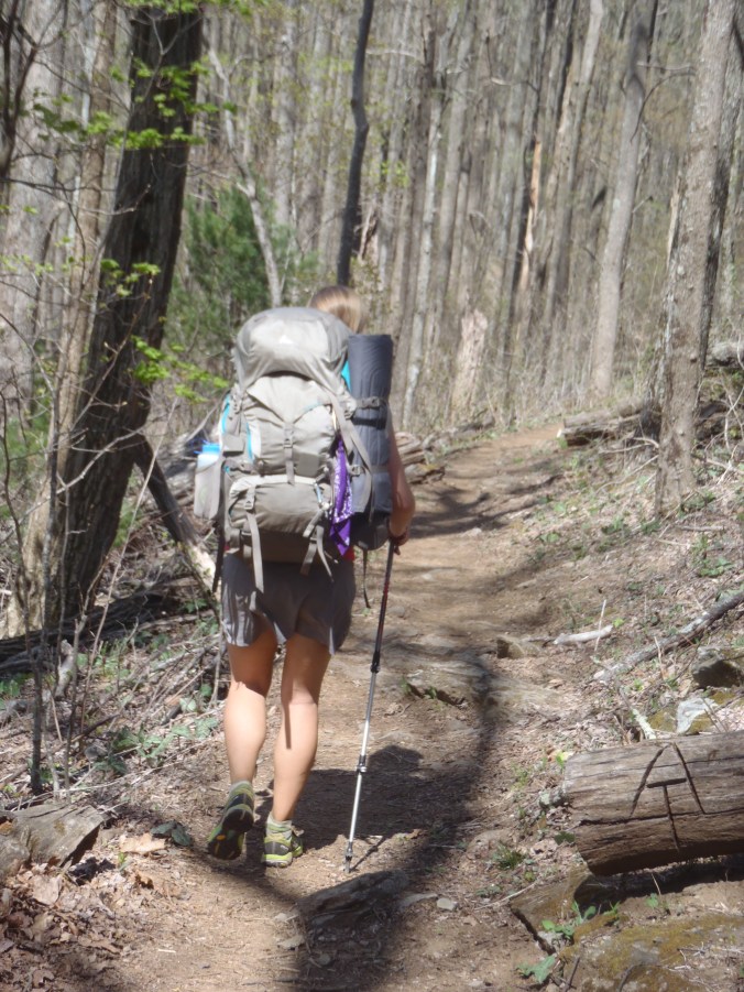 Lindsay walking by a cool chainsaw carving
