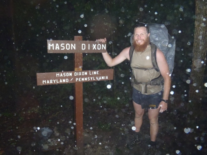 Clay posing at the Mason-Dixon line during a TORRENTIAL rain!